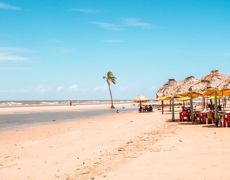 a beach with umbrellas and chairs and umbrellas, Marajó Island, Pará, Brazil