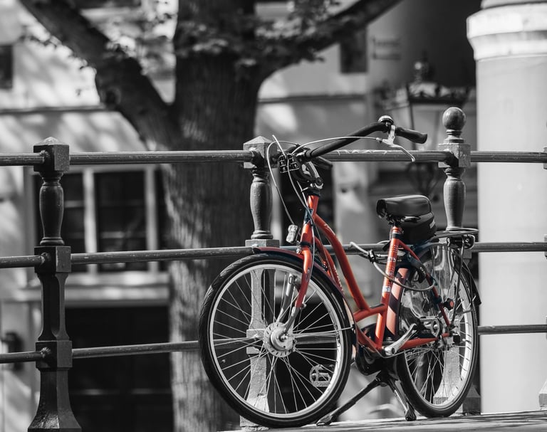 a red bicycle parked on a fence
