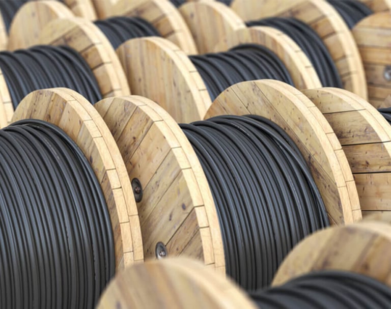 a bunch of wooden cable reels are lined up