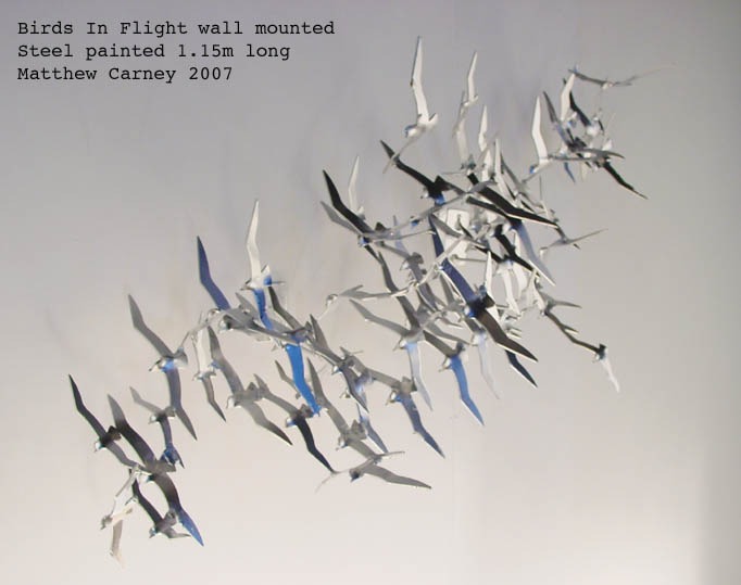 Steel sculpture of a flock of shearwaters in flight