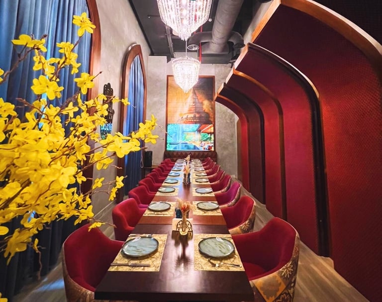a long table with a vase of flowers and a vase of flowers