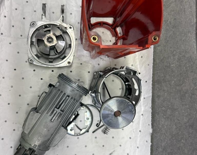 a red plastic container with a red handle and a red handle