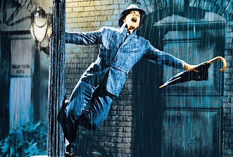 Gene Kelly sings on a lamppost with umbrella during ‘Singin’ in the Rain’ (1952)