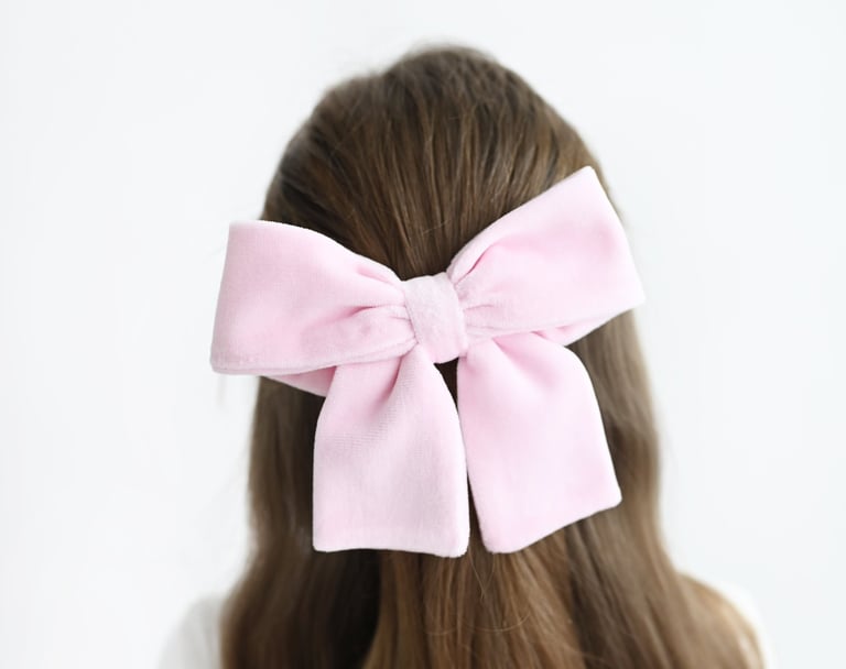 a woman with a pink bow tie on her hair