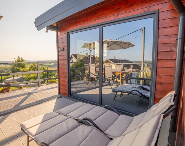 a wooden deck with a chair and a table