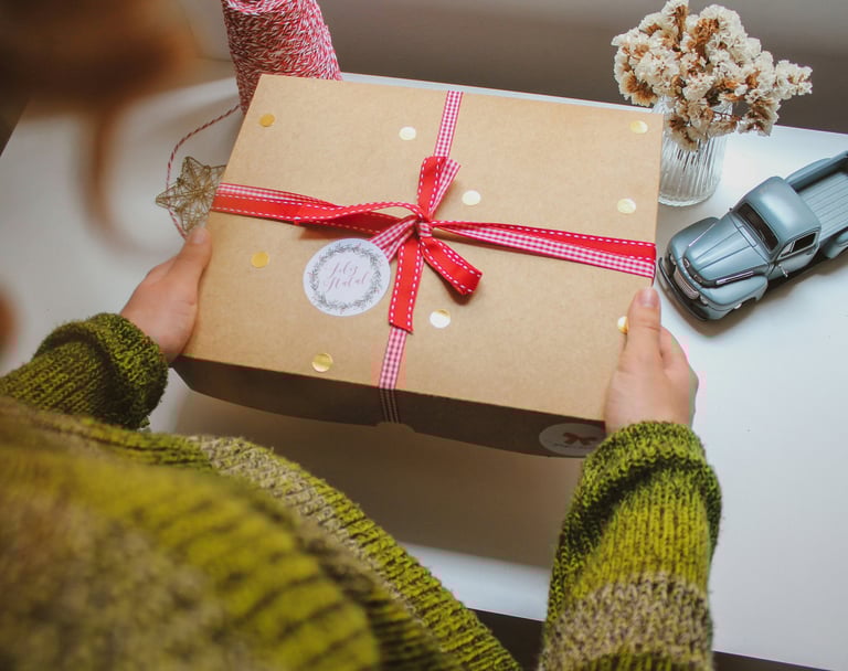 Woman is holding a gift box