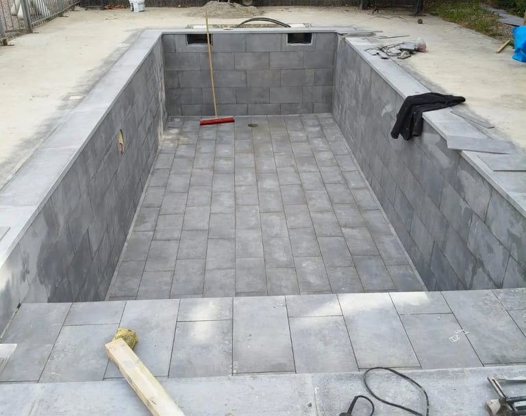 a pool with a concrete pool and a concrete pool