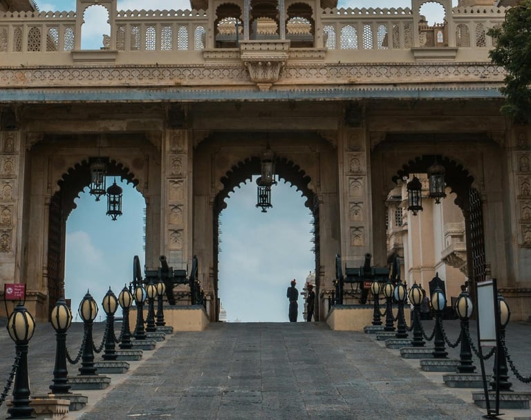 a large archway with a clock tower in the middle of a paved road