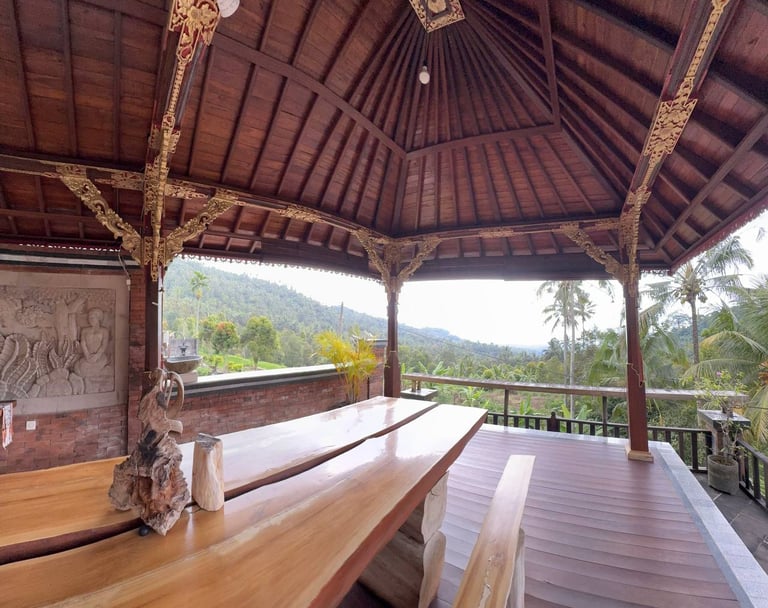 Interior of Joglo house with exposed antique teak beams creating a warm and elegant architectural space