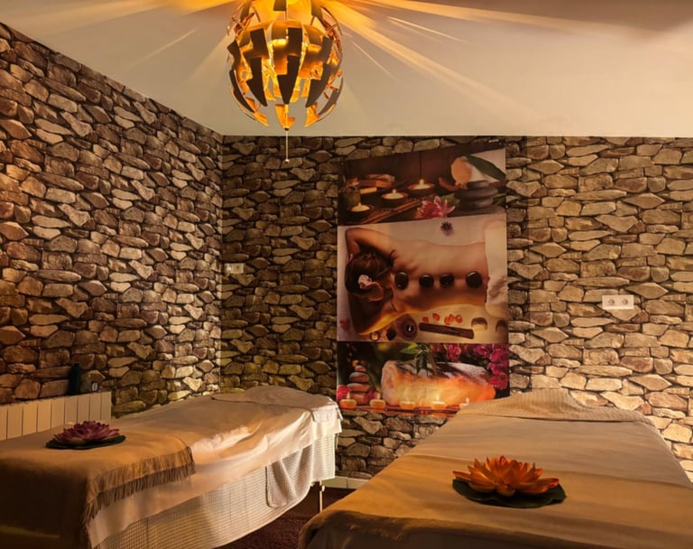 a couple of beds in a room with stone walls