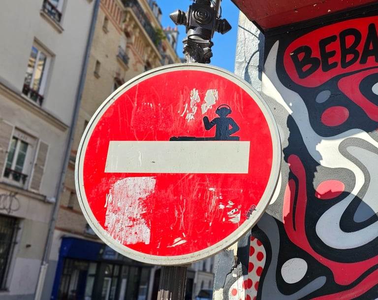 a red and white sign with a no entry sign