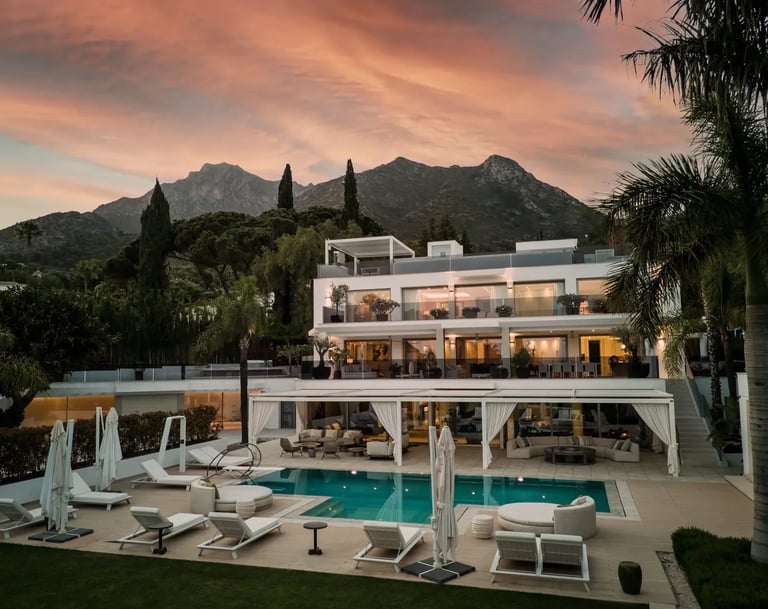 Sunset view of Villa Serenity exterior with pool and gardens