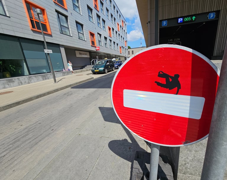 a red and white sign with a picture of a man on a skateboard