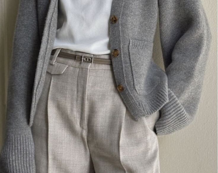a man in a white shirt and gray pants
