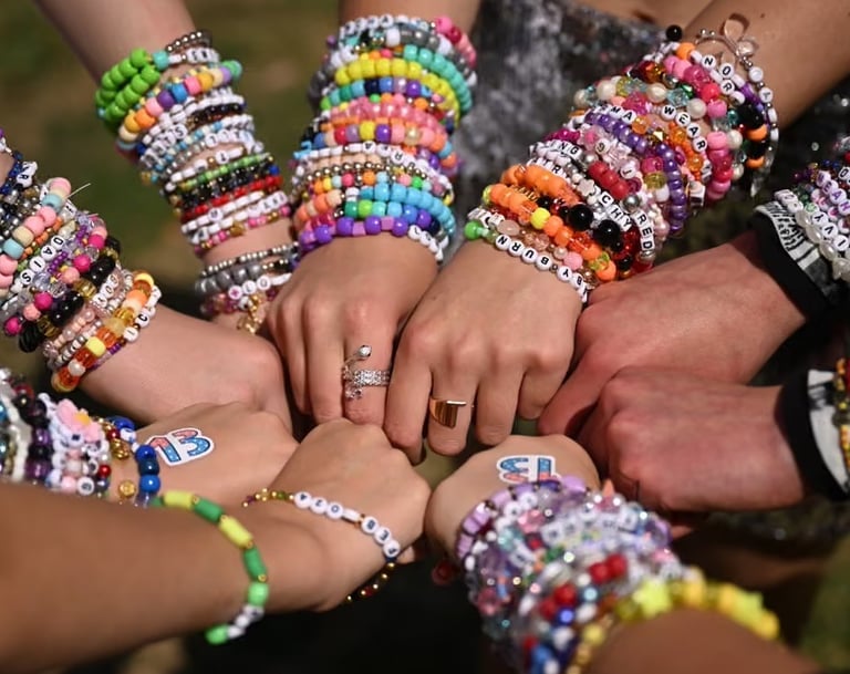 Fans exchanging colorful friendship bracelets at Taylor Swift Eras Tour.