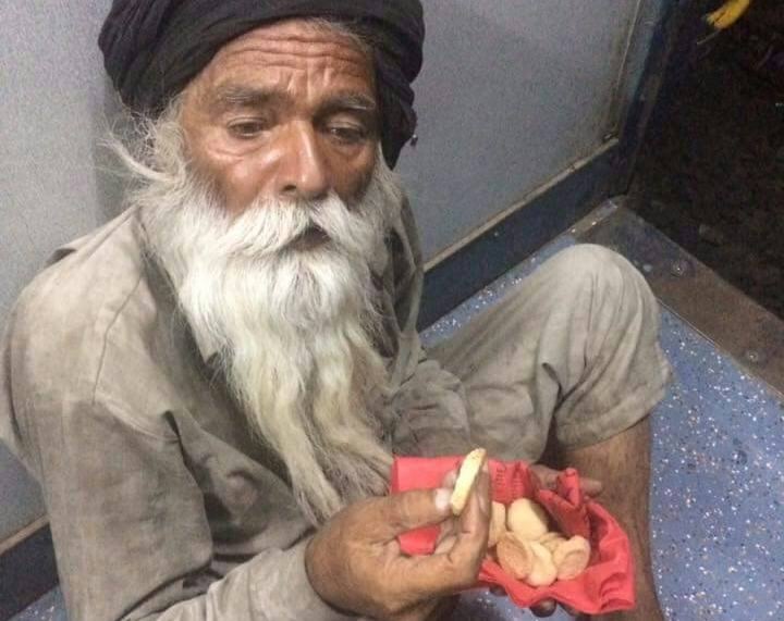 an old man with a white beard eating biscuits