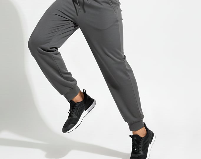 a man in a black shirt and grey pants