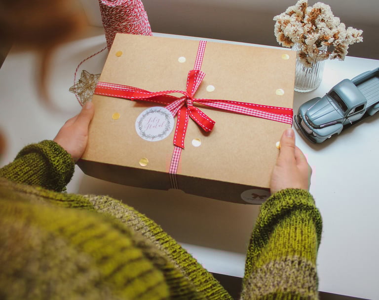 Woman is holding a gift box