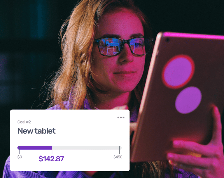 a woman in glasses and glasses is looking at a tablet