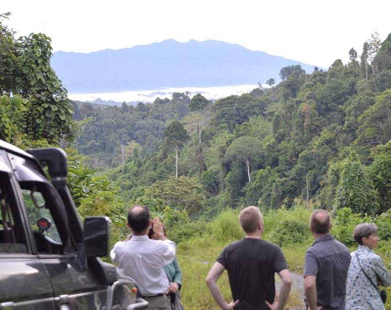 a group of people standing around a vehicle