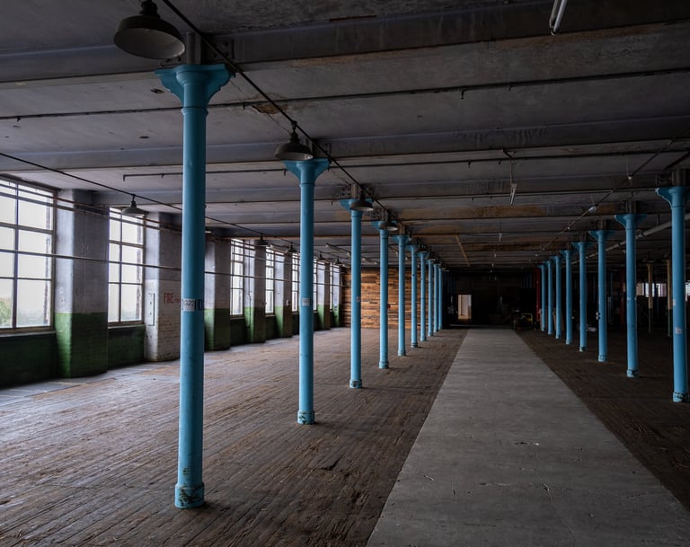 Image of the main room showing the wooden floor, Pillars, large windows and Palletwall.