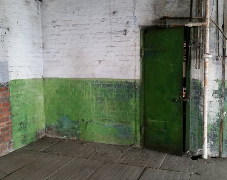 Industrial pipework, door and peeling walls located in the Stone room at Atlas Studios