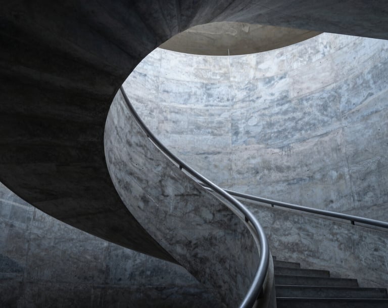 A vertical shot of a spiral staircase in a modern museum. The Charcoal Blue shadows and Dusty Slate concrete textures create a sense of infinite rhythm and depth.