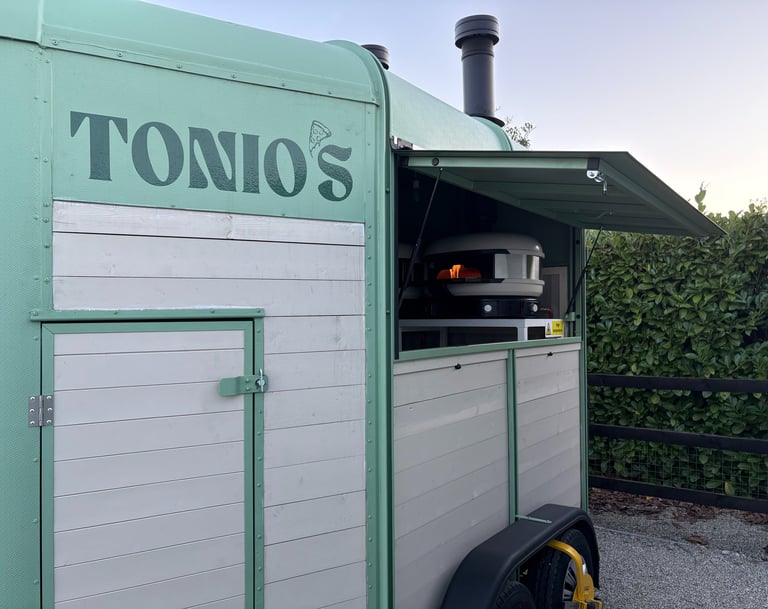 Tonio's green mobile pizzeria trailer