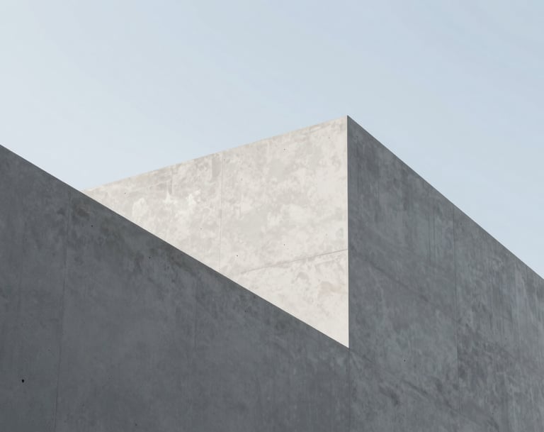 Sophisticated architectural photography of sharp, geometric concrete angles against a pale, clear sky. The image emphasizes professional creativity and minimalist aesthetics, using tones of #F5F4F0 and #AEAEA7 for a clean, modern look.