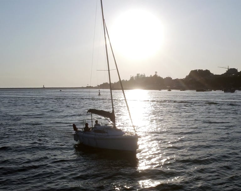 The sailboat Monark sailing on the Douro River at sunset