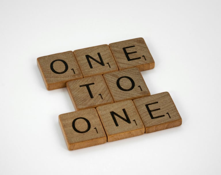 The Scrabble words "one to one" represent the option for one-to-one Spanish lessons to improve skill