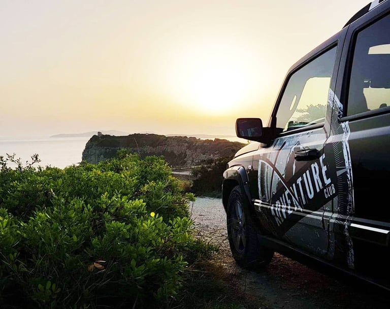 a black jeep parked on a dirt road