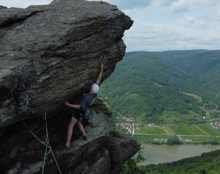 A climbing course participant climbing in an outdoor climbing course.