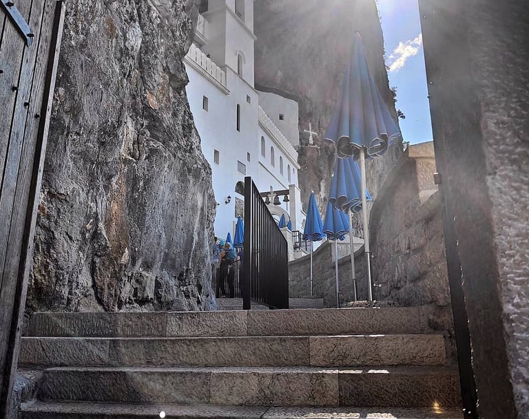 a stairway way to a building with umbrellas