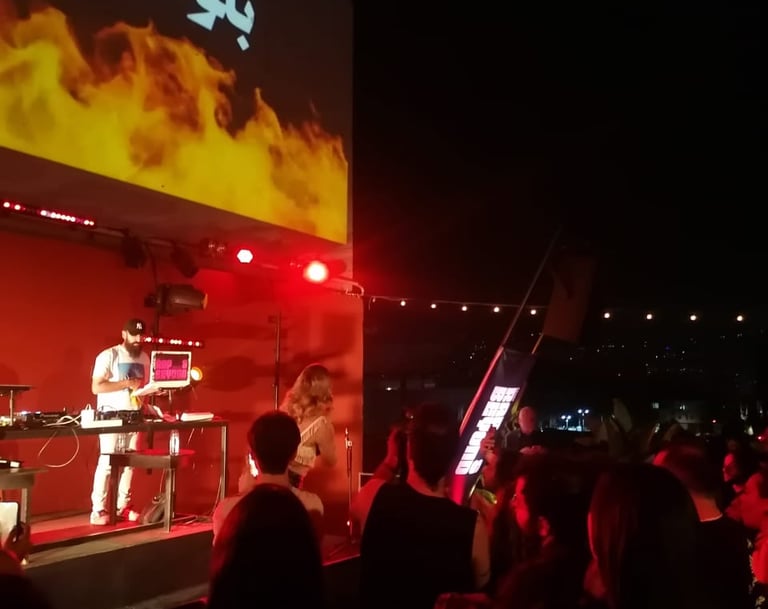 man standing in front of a screen with a video screen in a performance sound engineering for artist