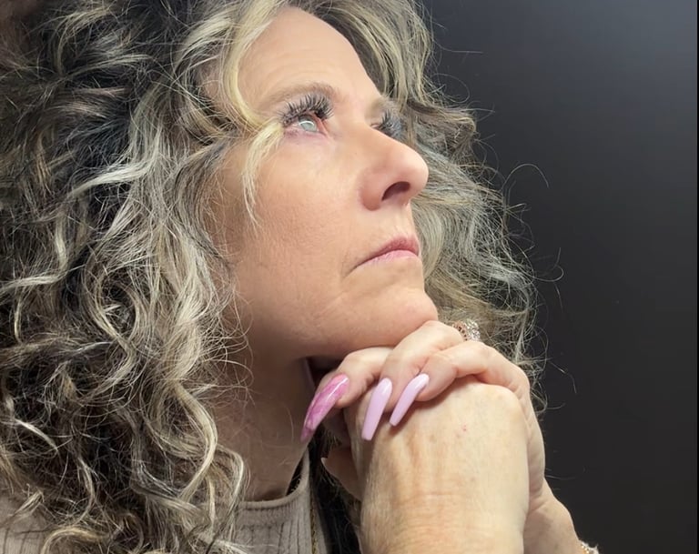 Experienced nail tech looking frustrated at her booking schedule, representing a nail tech income pl