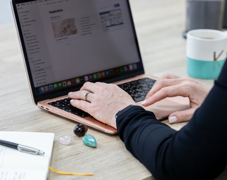 a person sitting at a desk with a laptop