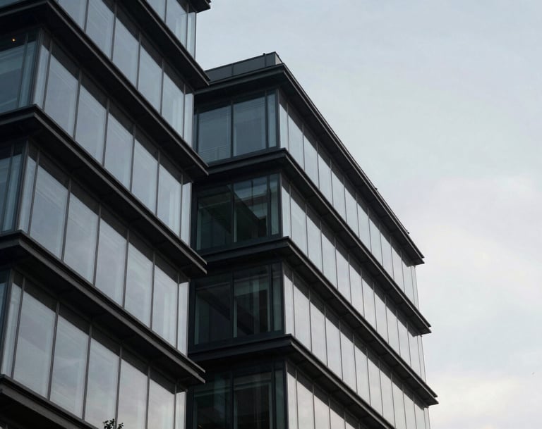 Detailed photography of sharp architectural angles against a soft gray sky, focusing on the intersection of glass and steel in a contemporary building, professional and refined, Global / Contemporary Art.