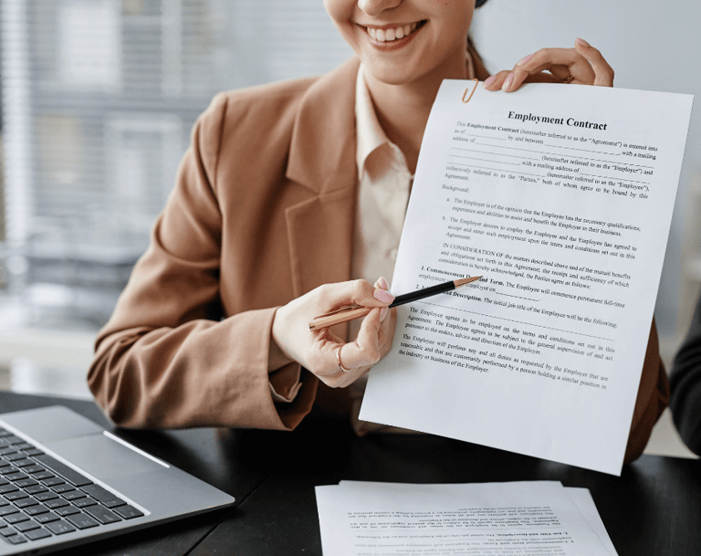 a woman in a suit is holding a pen and an employment contract