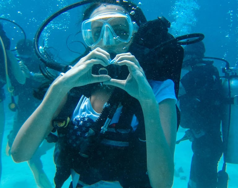 a woman in a diving suit is taking a selfie