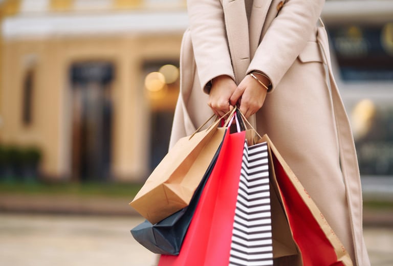 a woman holding shopping bags in her hand
