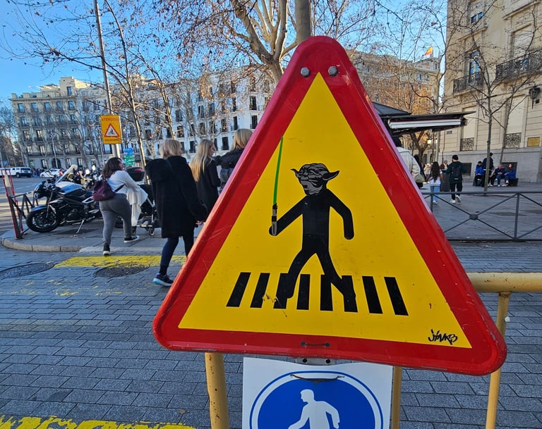 Street art sur panneau de signalisation représentant Yoda sur un panneau piéton