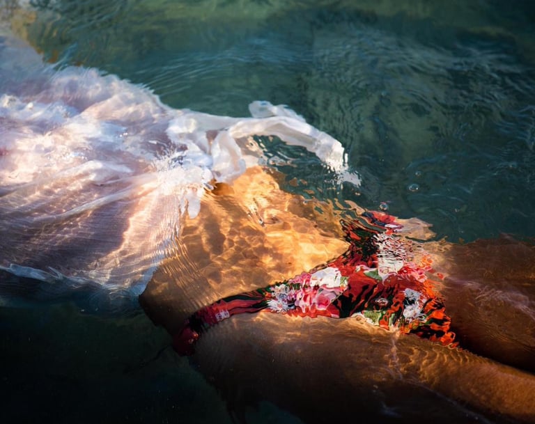 a woman in a bikini top is laying on the sea