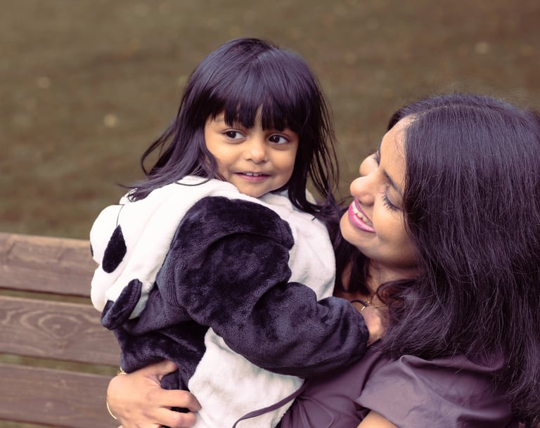 a woman in a panda bear suit is holding a stuffed animal