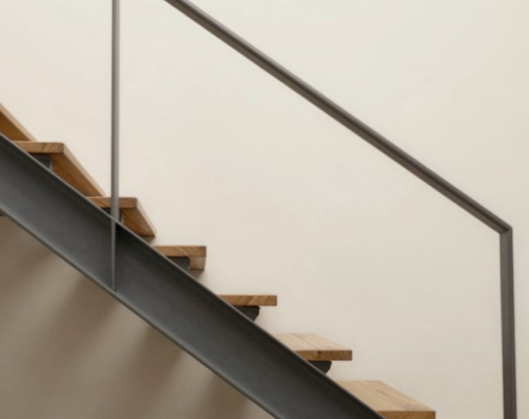 Clean architectural detail showing a staircase made of wood and metal, casting geometric shadows on a sand-colored wall (#F9F7F2). Soft, diffused natural light.
