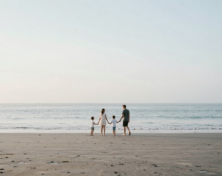 A wide shot of a family playing on a secluded Bali beach at dawn. The atmosphere is airy and minimalist, with soft blues and sandy tones matching #F8F4F0. Natural, unposed movement.