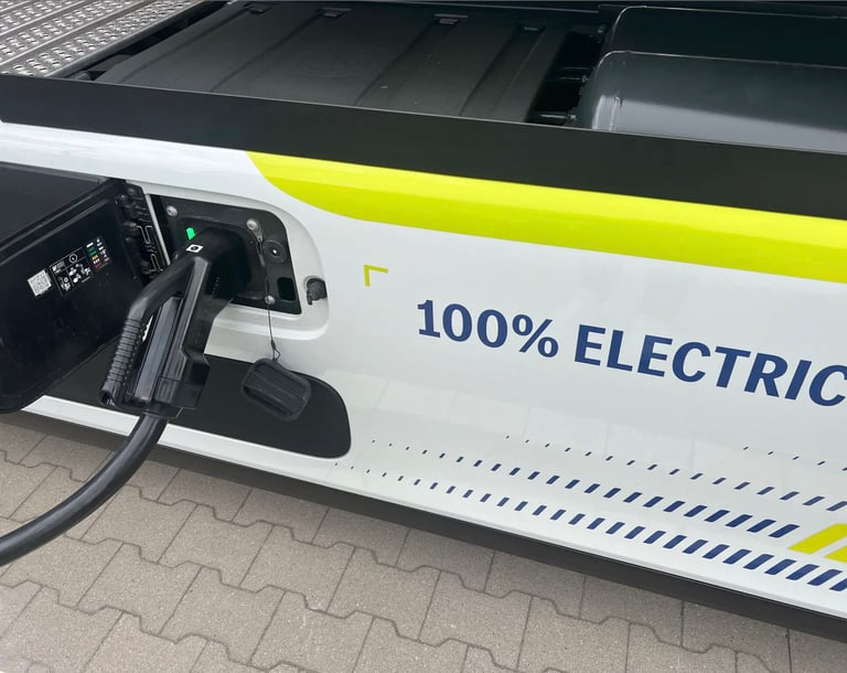 ladeinfrastruktur eLKW: a white electric vehicle with a green and yellow electric charging station