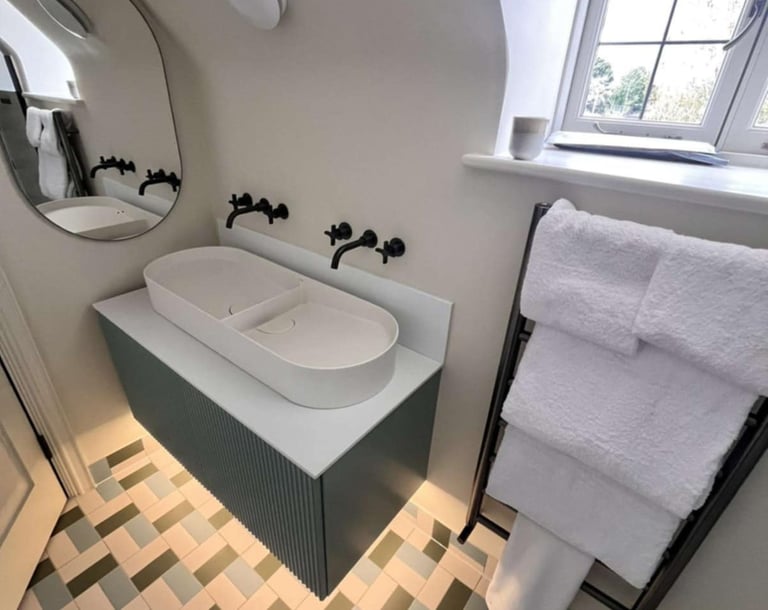 stylish bathroom with double sinks and chrome mixer taps in Evesham