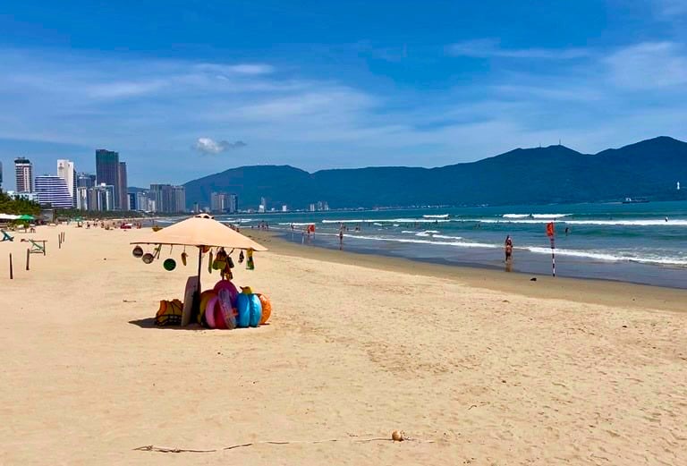 My Khe Beach Da Nang with swimmers and coastal buildings