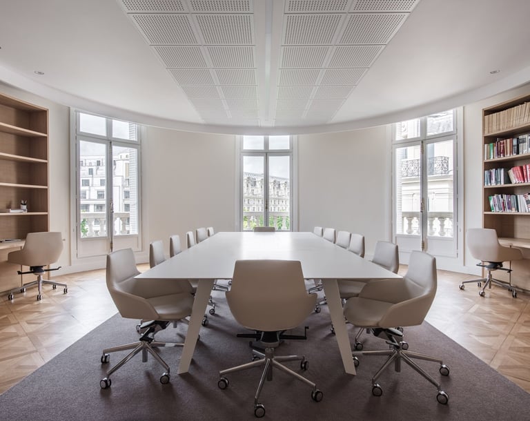 a modern conference room with a table and chairs